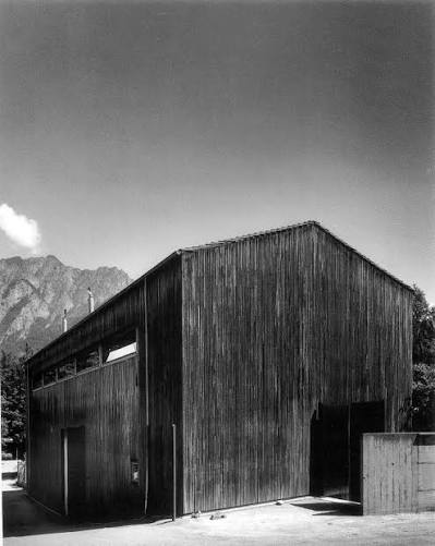 Timber-clad Peter Zumthor building against a mountain backdrop